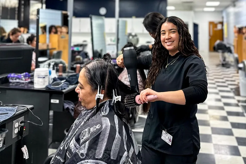 James Sprunt Costmetologu Student cutting hair