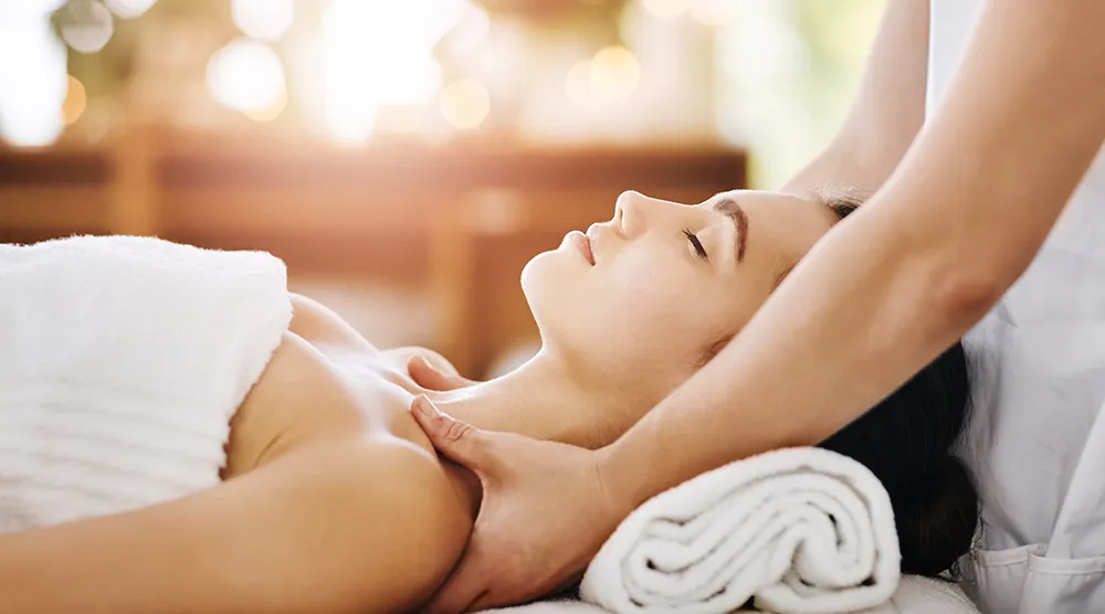 Massage therapist relaxing tense neck muscles